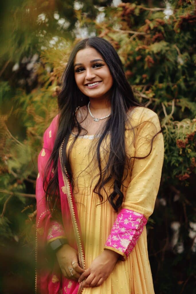 senior girl in a yellow and pink dress