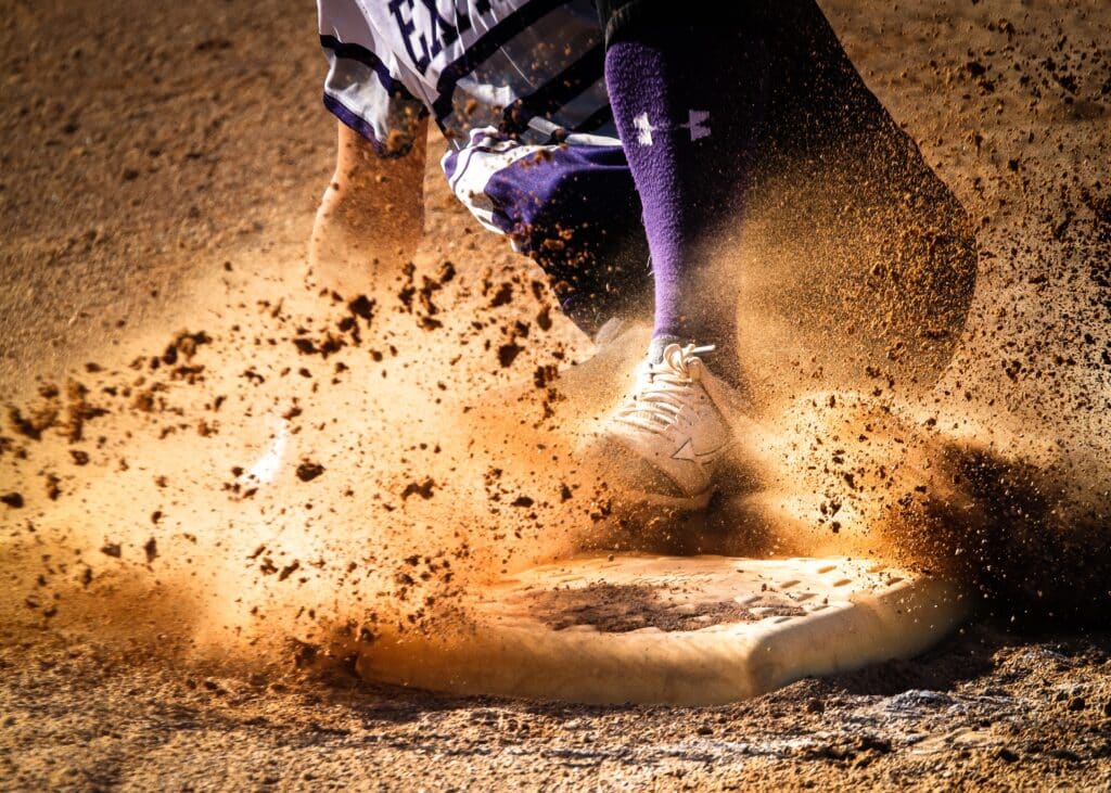 baseball player sliding into base