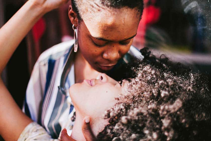 portrait of lesbian couple embracing while looking in each others eyes