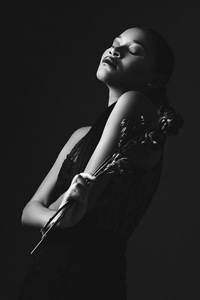 black and white portrait of a black woman holding flowers