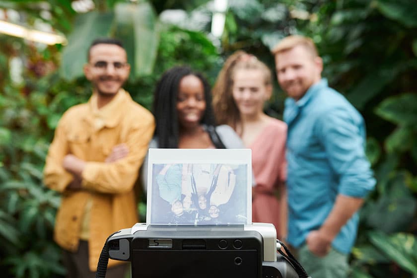 friends in background with polaroid print in the foreground