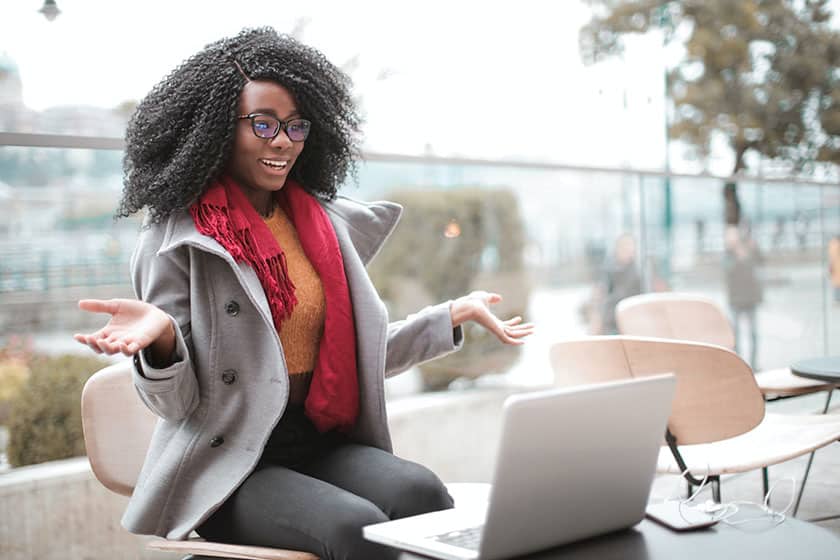 cheerful surprised woman looking at laptop