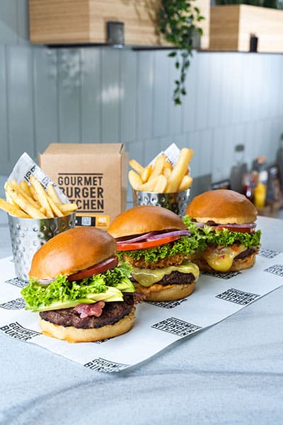 3 burgers lined on counter