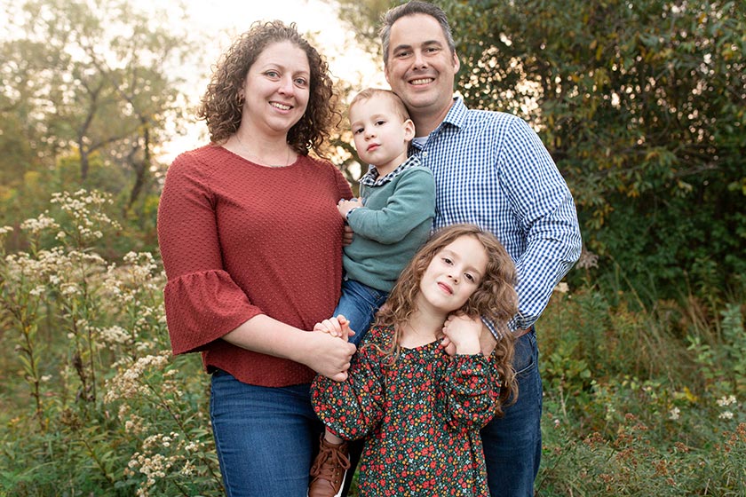 mother and father holding son and daughter