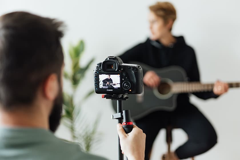 photographer viewing client through the back of a digital camera screen