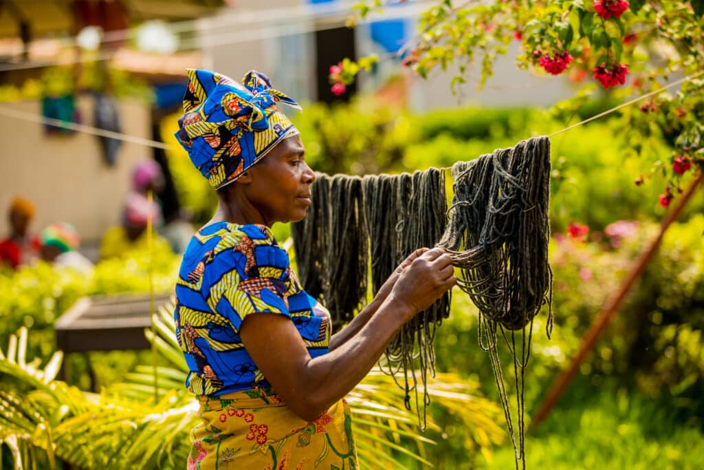 Laura Grier female artisan drying dyed wool on a clothesline