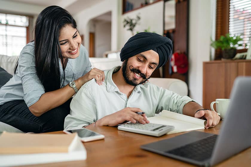 couple using calculator and computer