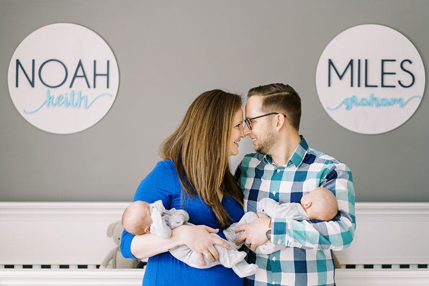 parents each holding a newborn twin