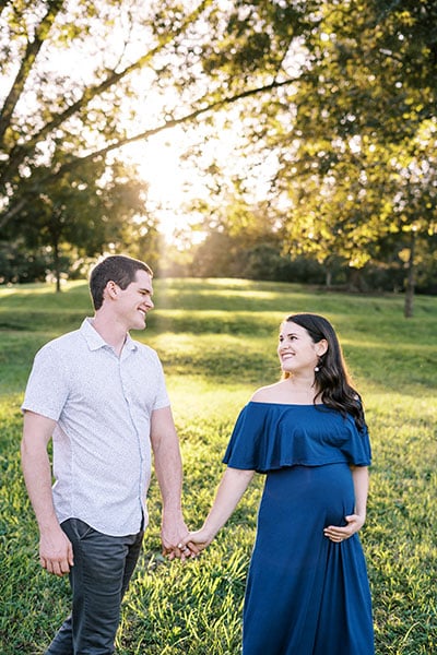 pregnant woman holding hands with partner