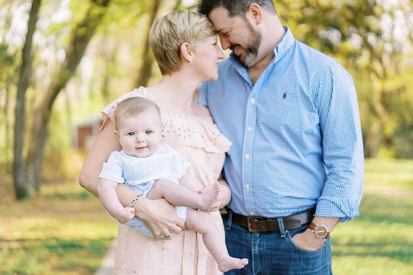 baby with mama and daddy looking at camera