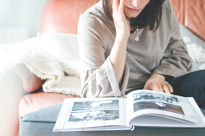 woman looking at photo album