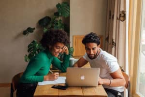 woman and man smiling at computer