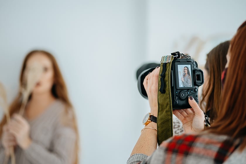 photographer looking at back of camera during portrait session