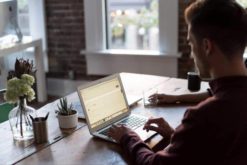 photographer working on laptop sitting at desk