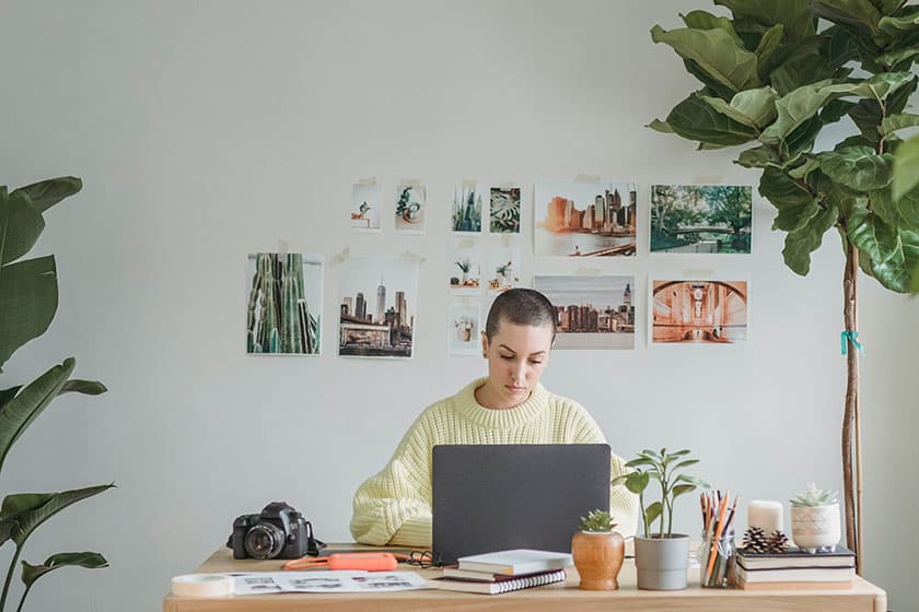 photographer at desk using laptop