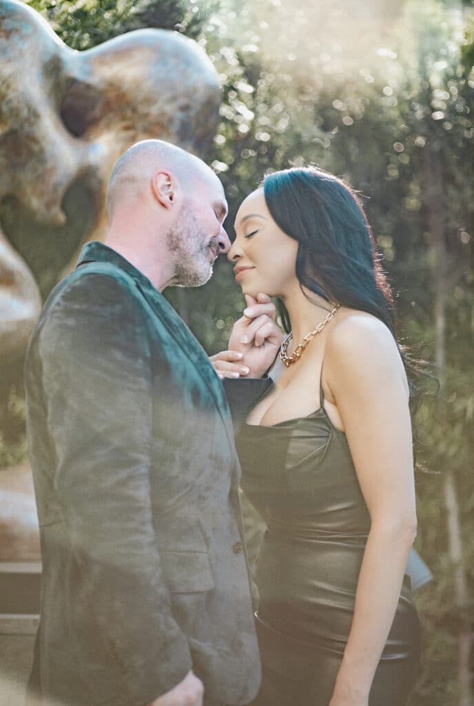 man and woman facing each other behind a lens flare photo by Rhonda Dumas of PieFace Photography