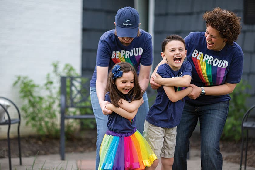 LGTBQ family dancing and wearing rainbow colors