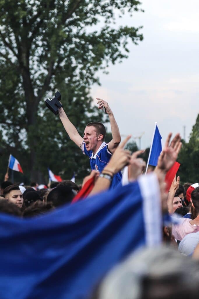 sports fans celebrating in a crowd