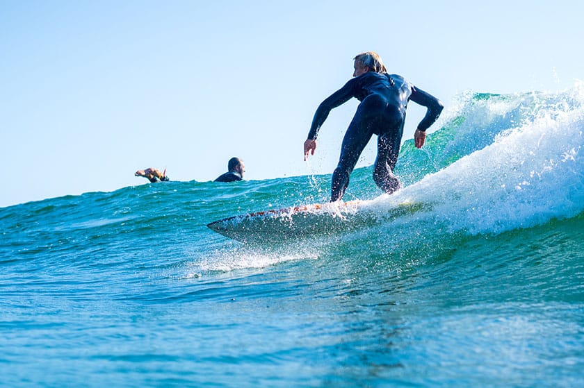 surfer in wetsuit riding a wave