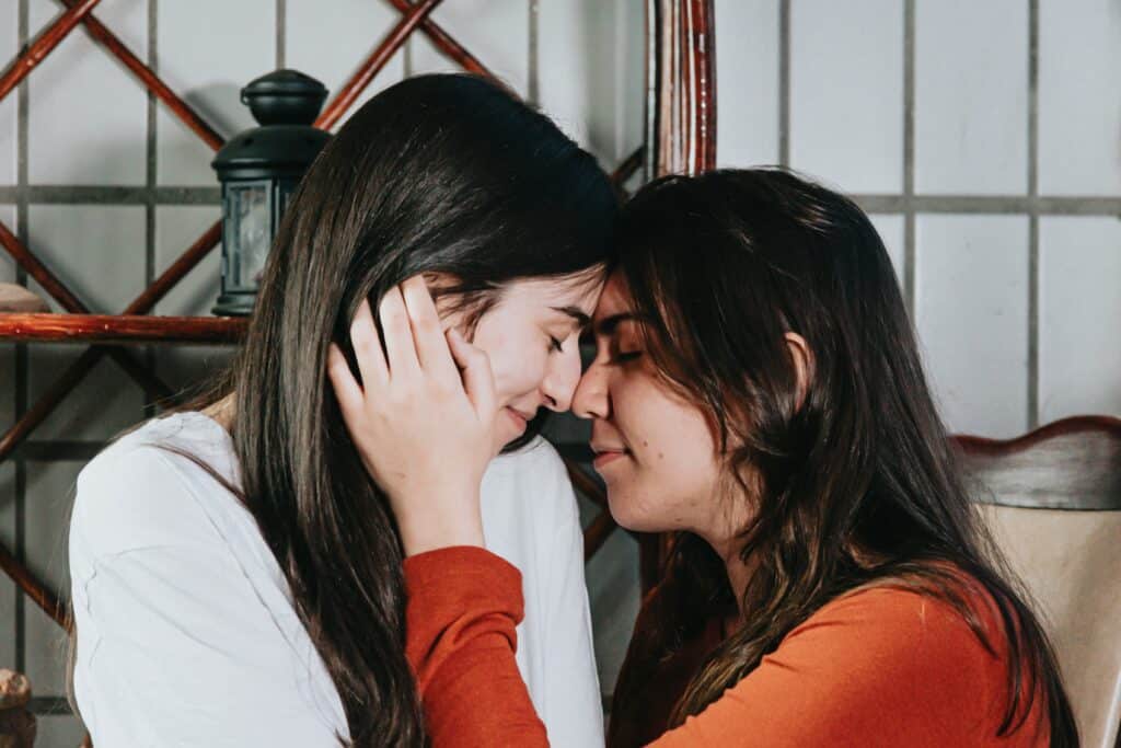 two women with foreheads and noses touching