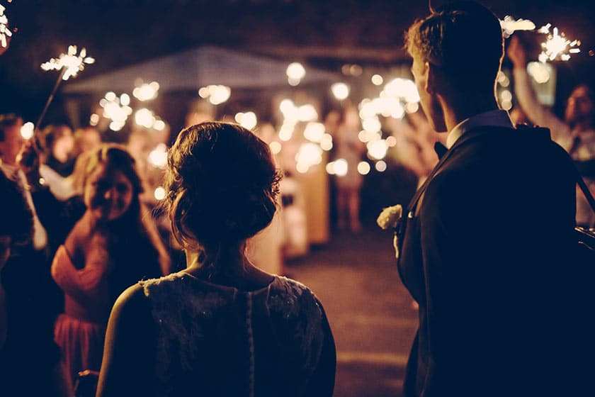 bride and groom watch wedding festivities