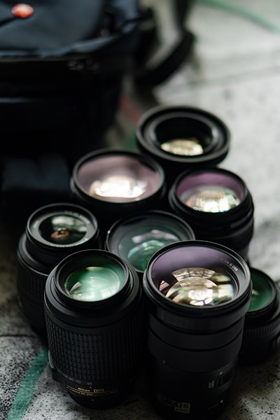 camera lenses reflecting the sun on a surface 