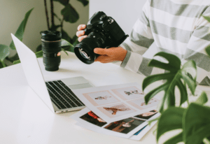 photographer working with laptop computer and camera